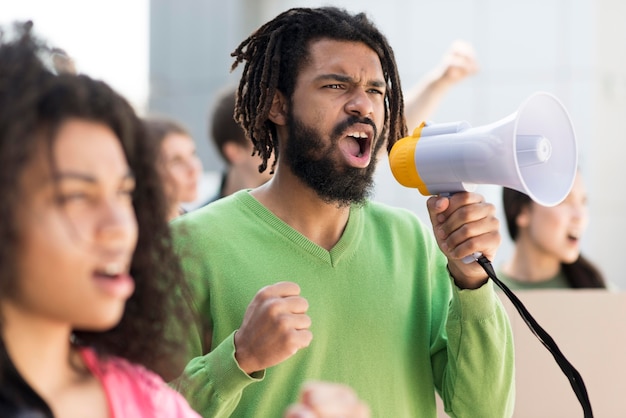 Free Photo people protesting in the streets with megaphones