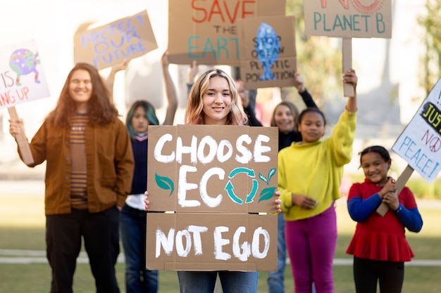 Free photo people protesting with placards outdoors for world environment day