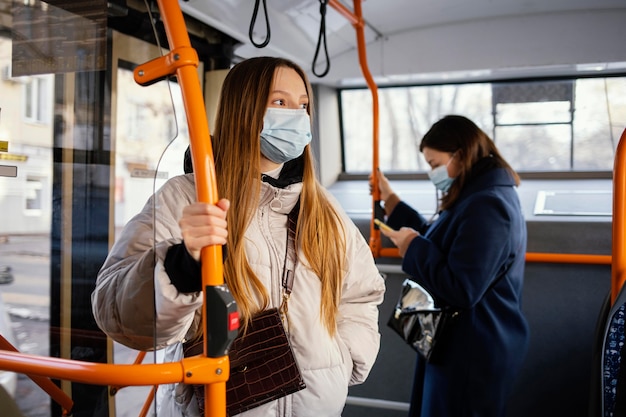 Free Photo people in public transportation wearing mask