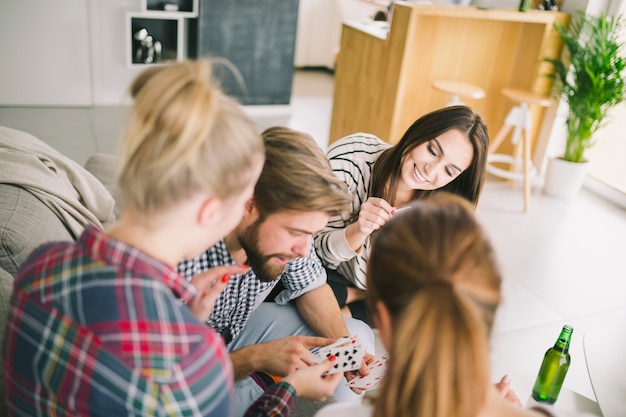 People relaxing with playing cards at home