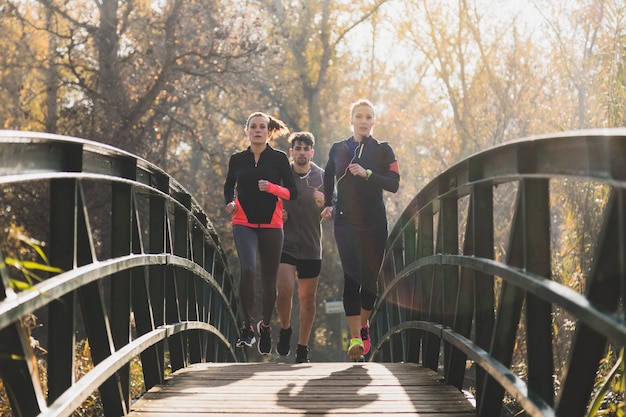 Free photo people running across a bridge