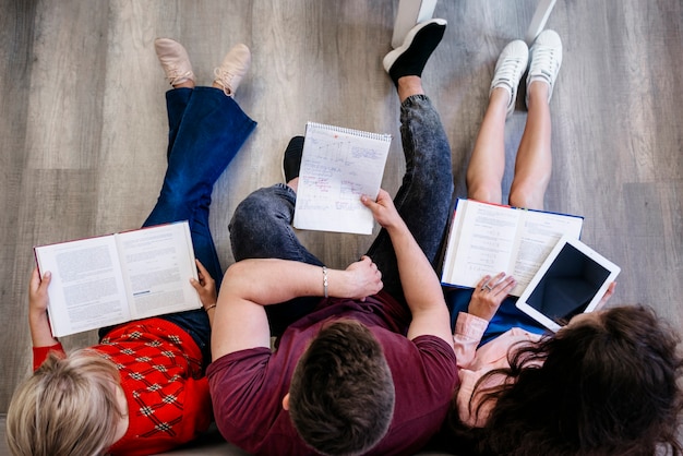 Free Photo people sitting on floor studying