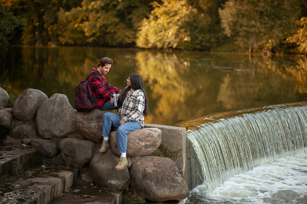 Free photo people sitting in nature full shot