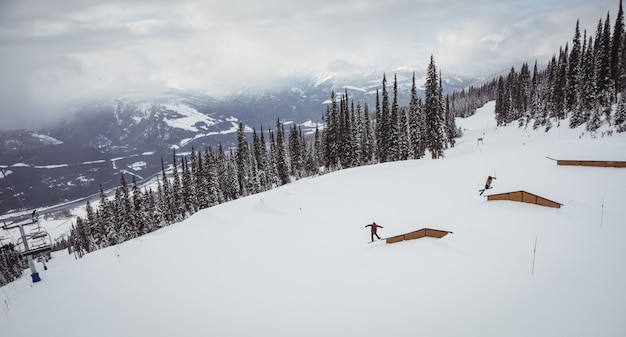 People skiing on snowy alps in ski resort