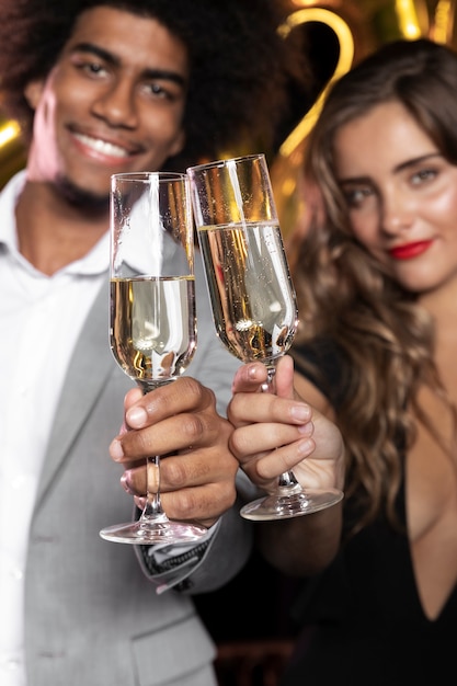 People smiling and holding glasses of champagne close-up