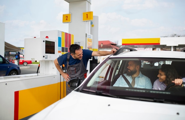 Free Photo people spending time at the gas station