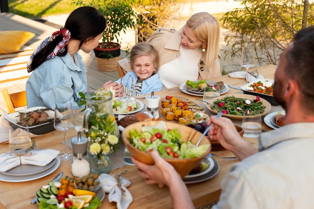 People at table with tasty food close up