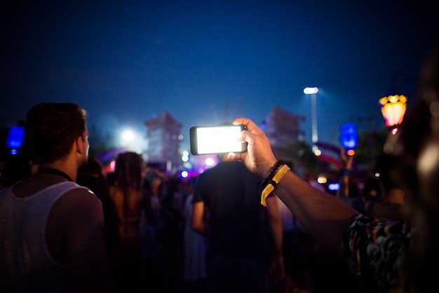 Free photo people taking photo in music concert festival