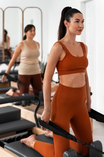 People taking  pilates reformer class