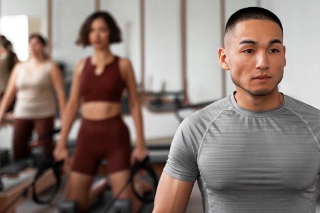 People taking  pilates reformer class