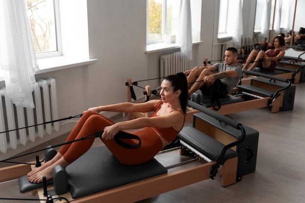 People taking  pilates reformer class