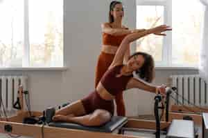 Free photo people taking  pilates reformer class