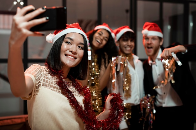 Free Photo people taking a selfie at a new year's eve party