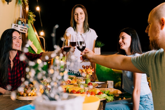 People toasting wine at party