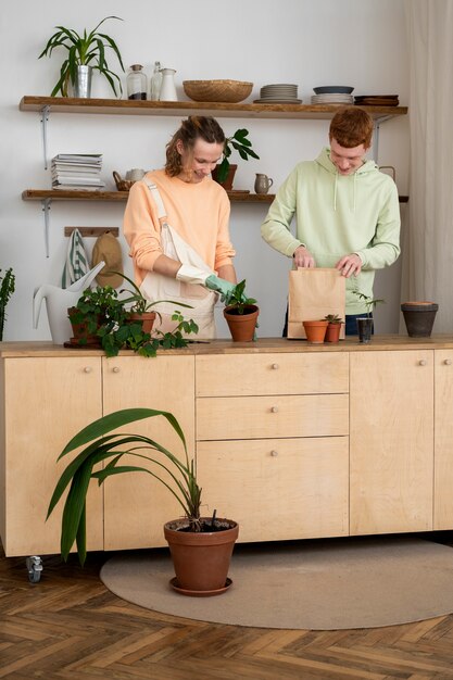 People transplanting plants in new pots