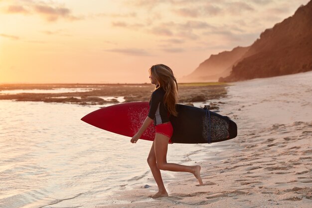 People and travel concept. Shot of slim surfer with perfect figure