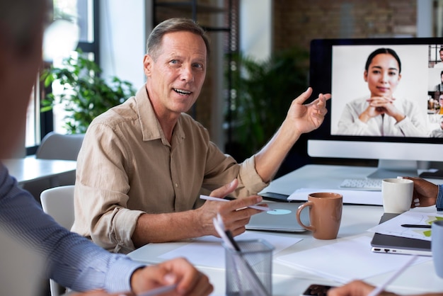 Free photo people using digital device while in a meeting