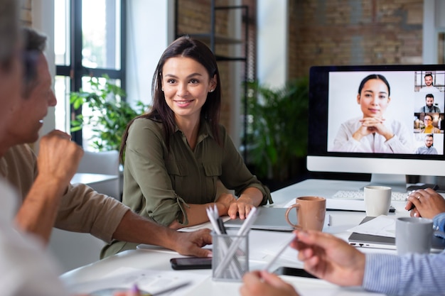 Free photo people using digital device while in a meeting