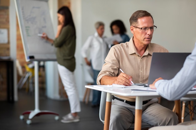 People using digital device while in a meeting