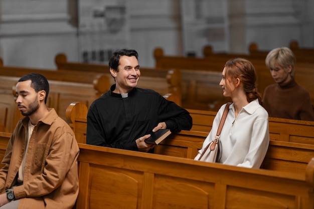 Free photo people visiting and praying in church building