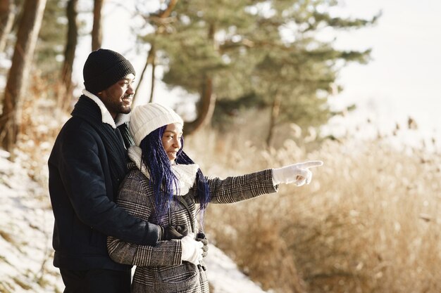 People walks outside. Winter day. African couple