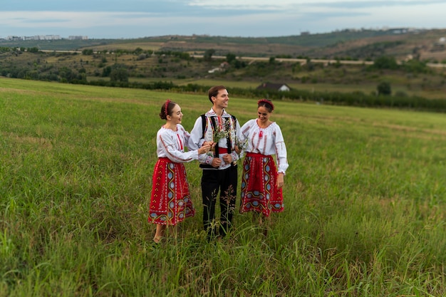 Free Photo people wearing traditional clothes full shot