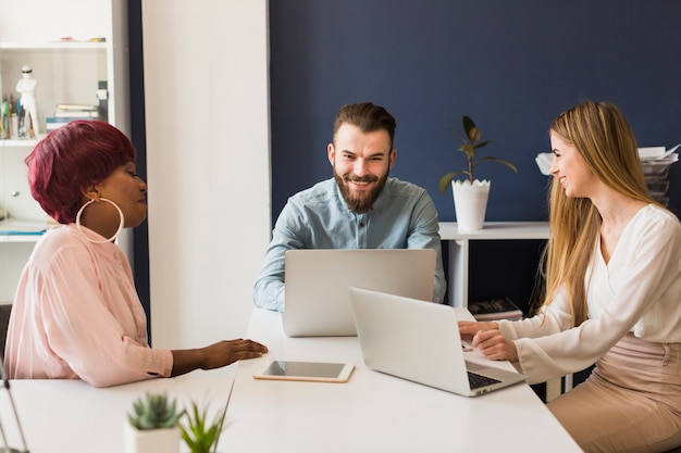 Free photo people with laptops in office