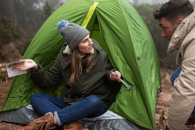 People with map and tent talking