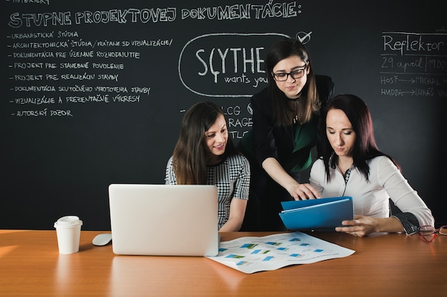 People working with documents and laptop