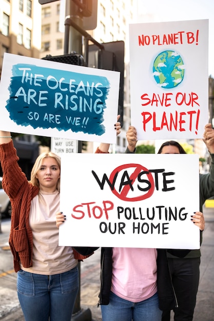 Free photo people at a world environment day protest with placards outdoors