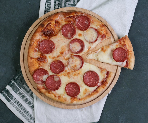 Free photo pepperoni pizza with melted white cheese on the top.