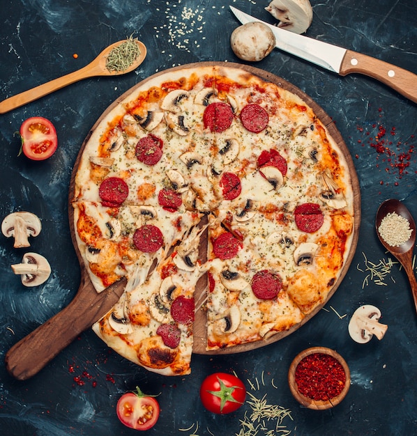 Pepperoni pizza with mushrooms on the table