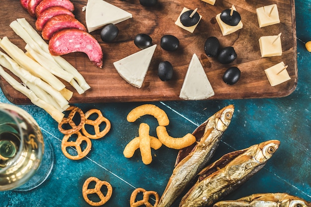 Pepperoni slices, cheese and black olives served with dry fish and crackers