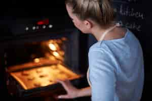 Free photo perfect housewife baking her favourite cookies