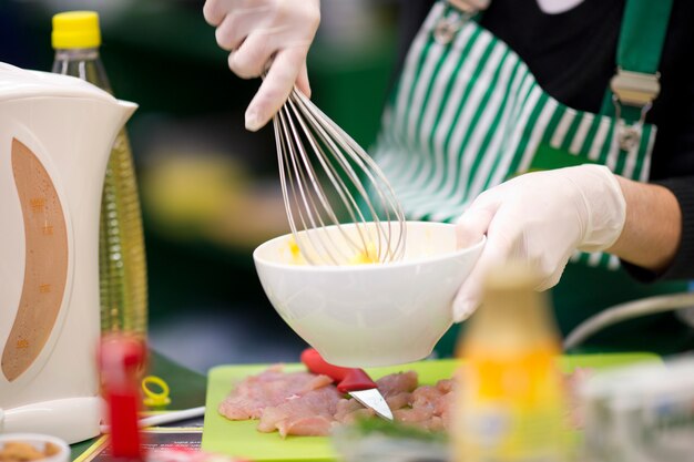 Person beating eggs in a bowl