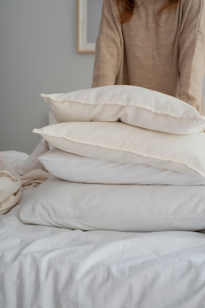 Person in bedroom with bed decor