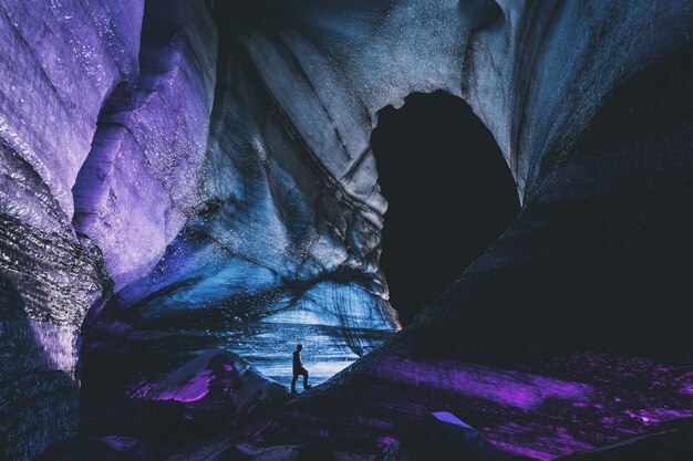 Person in black jacket standing on rock formation