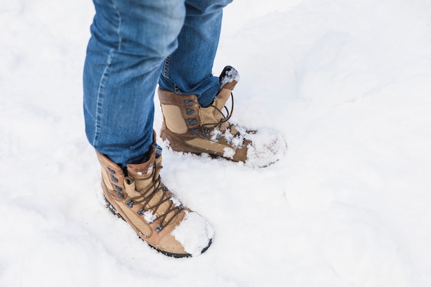 Free photo person in boots standing on snow