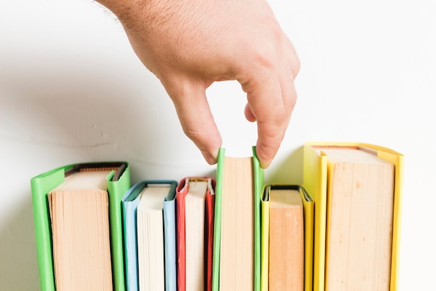 Free Photo person choosing book from shelf