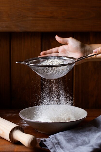 Person cooking with flour