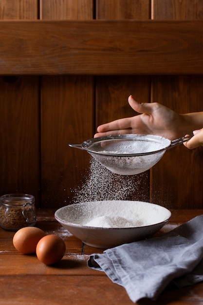 Person cooking with flour