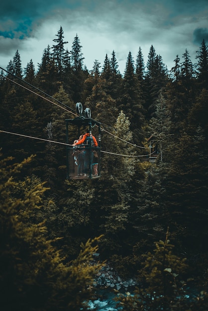 person crossing a river in a cabin