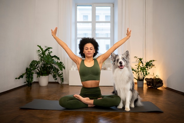 Person doing yoga accompanied by her pet