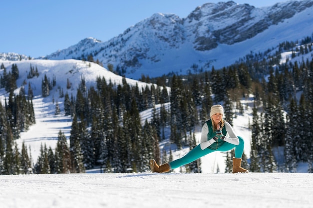 Free photo person doing yoga in cold and wintry weather