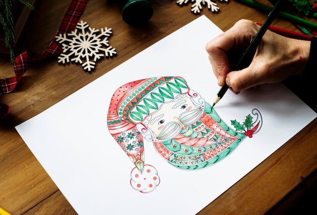 Free Photo a person drawing a colorful santa claus' face