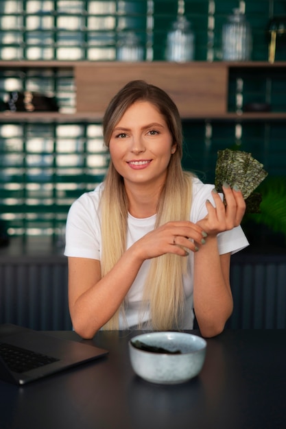 Free photo person eating seaweed snacks