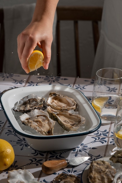 Free photo person enjoying a dish made of oysters