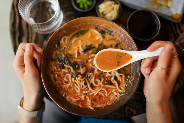 Person enjoying food at restaurant