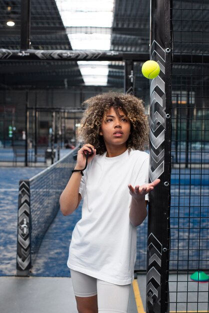 Person getting ready to play paddle tennis inside