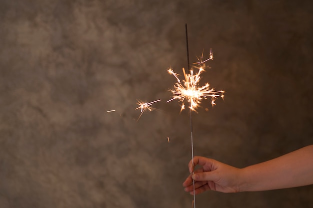 Free Photo person hand with flaming bengal light in fog